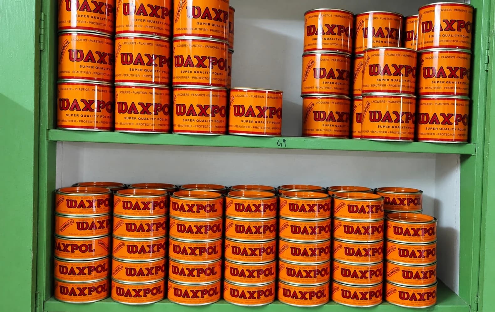 Waxpol wax polish tins stocked on shelves in the Covai Seenu godown