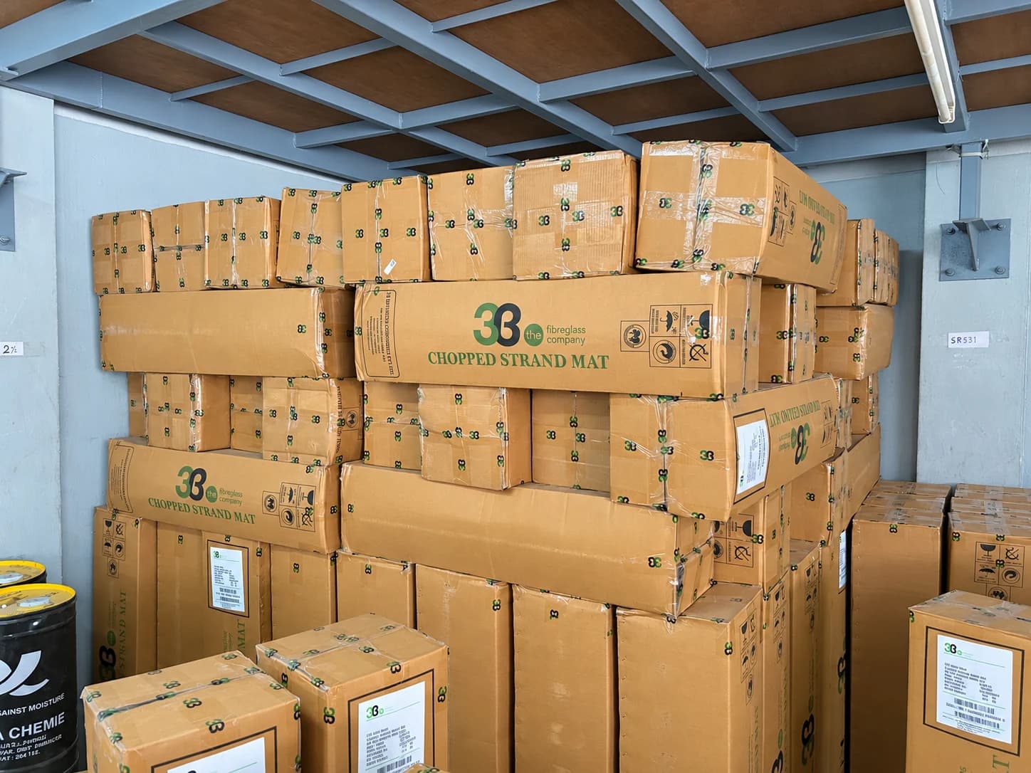 3B fibreglass mat cartons stacked in the Covai Seenu godown