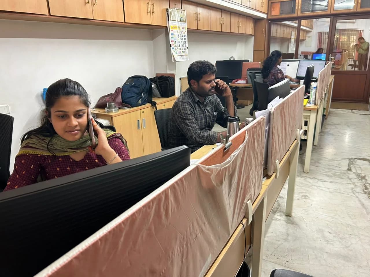 Covai Seenu staff assisting customers by phone in the office